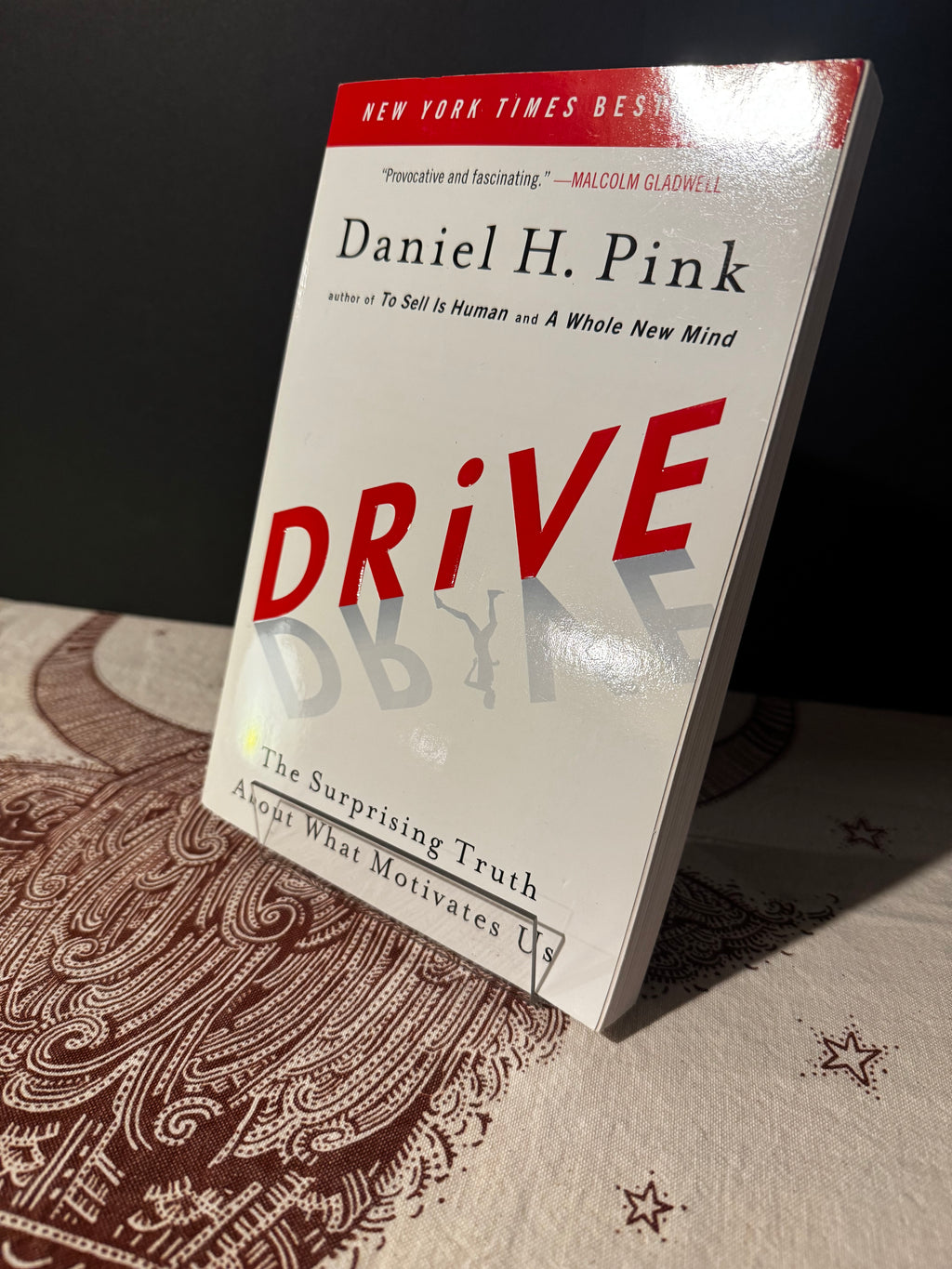 Book titled 'Drive' by Daniel H. Pink on a textured surface