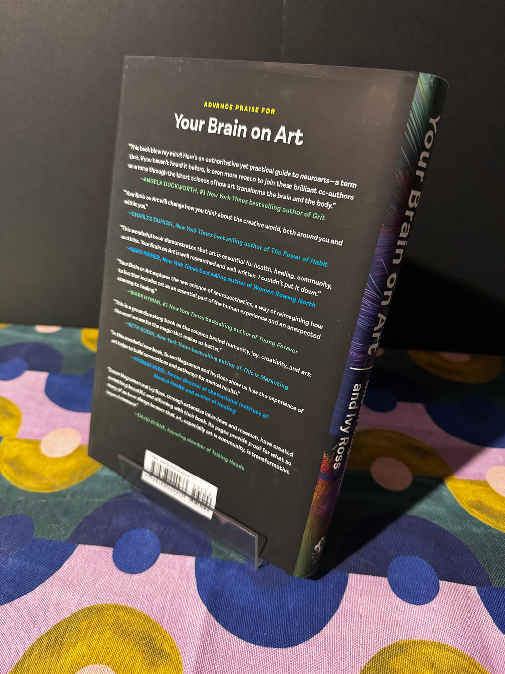 Book titled 'Your Brain on Art' on a colorful fabric background