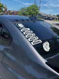 Car window with multiple decals featuring years and a logo.