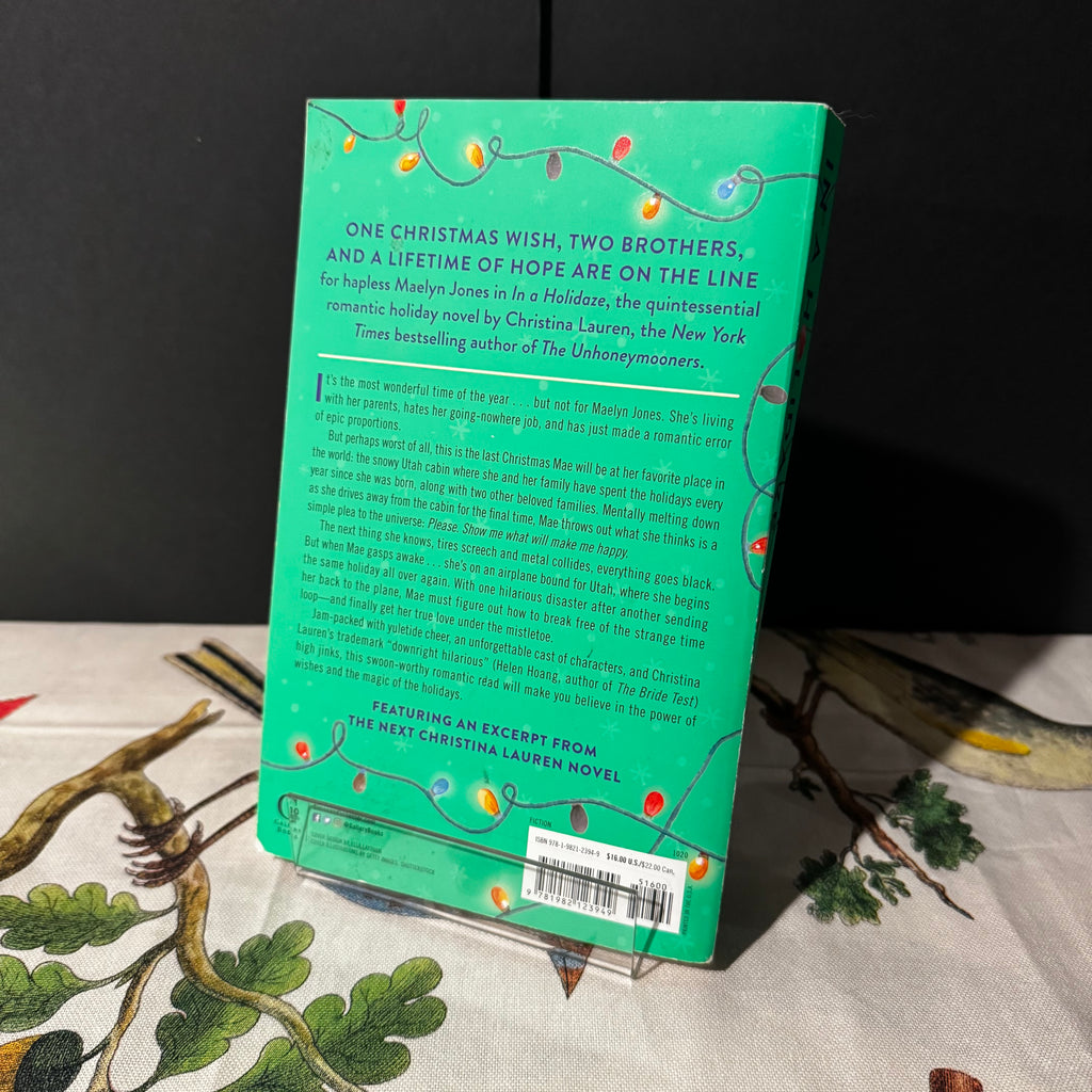 Green book cover with text and Christmas lights on a dark background