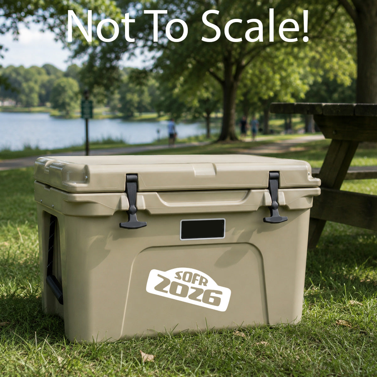Beige cooler box with 'SOFR 2026' logo in a park setting