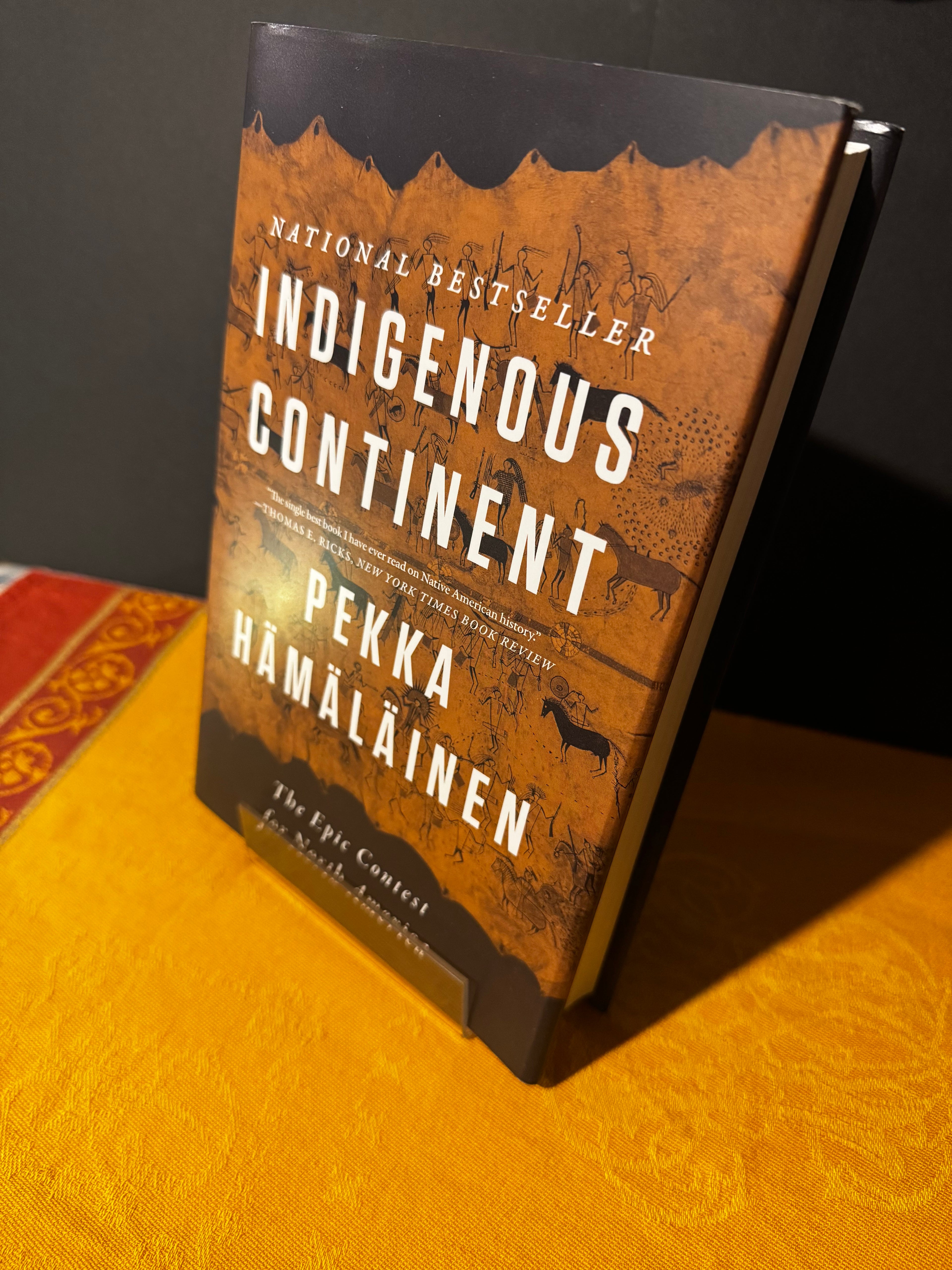 Book titled 'Indigenous Continent' by Pekka Hamalainen on a textured surface